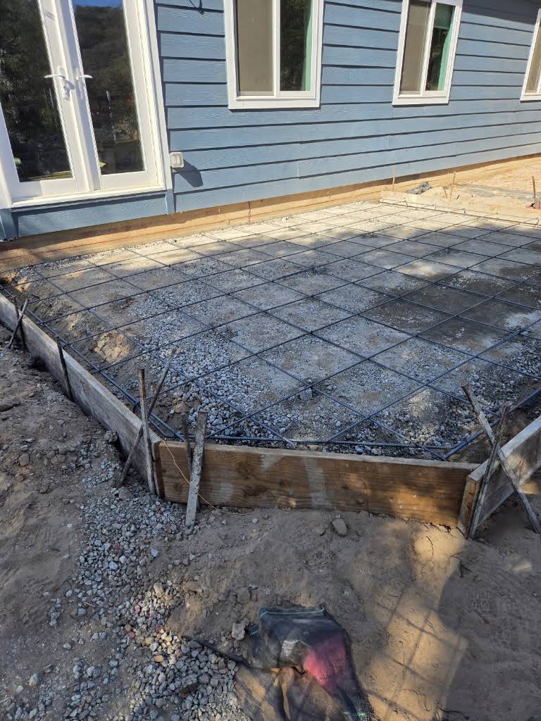 Reinforced concrete preparation beside a residential home