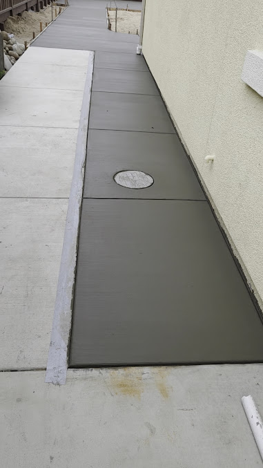 Finished concrete walkway along a residential property